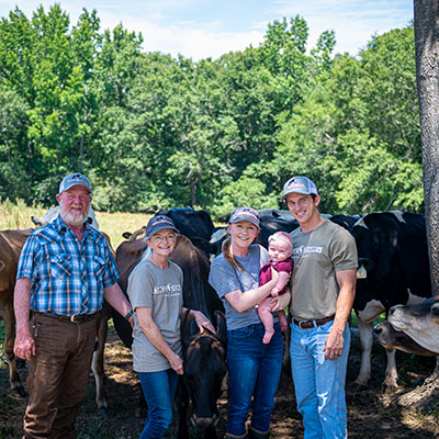 The Junkin and Vails family with dairy cattle